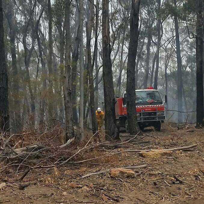 A Tallong Bushfire Brigade member hard at work off Caoura Road. Photo supplied.