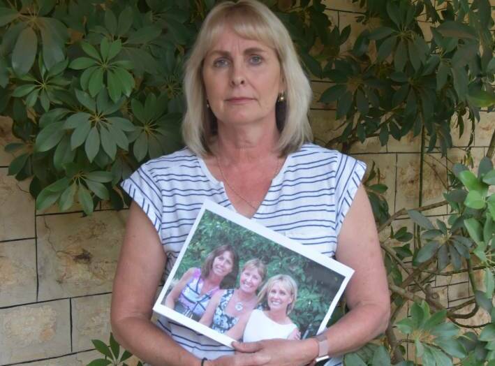 FIGHTING: Andrea Hannemann, pictured with a photo of her with her sisters, Wendy and Gayle, is fighting to get Gayle's Law recognised federally to provide safer working conditions for remote and rural nurses and health workers.

