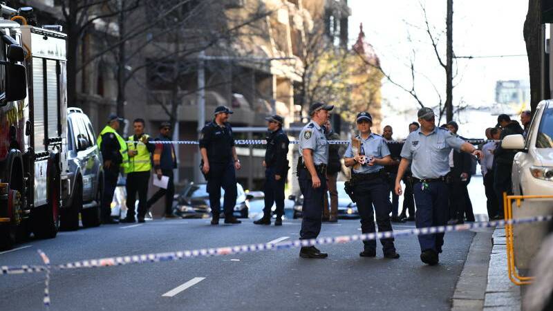 Police are seen during a police operation at the corner of King and York Street in Sydney