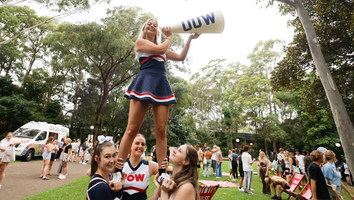 Erica Abrahams from the UOW Cheer and Dance Squad spreads the word on the first day of O-Week on Monday. Picture by Anna Warr