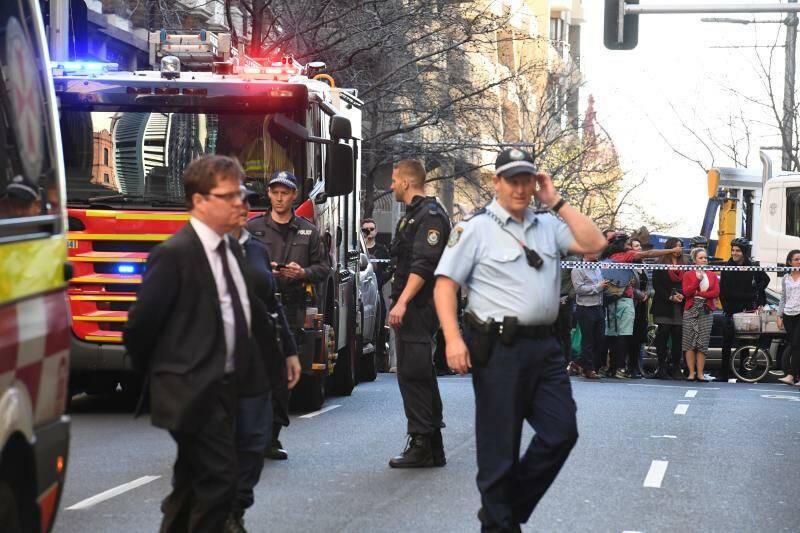 Police are seen during a police operation at the corner of King and York Street in Sydney.