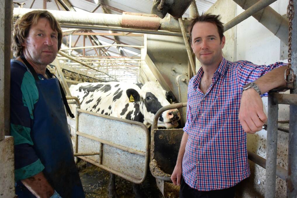 COMMUNITY CARES: Gavin Chittick on his dairy farm with Kangaroo Valley Agricultural Fund committee member Mark McLennan. 