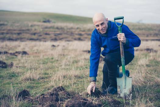 TWO FOR ONE: Officeworks managing director Mark Ward planting for Restoring Australia. Photo: supplied. 