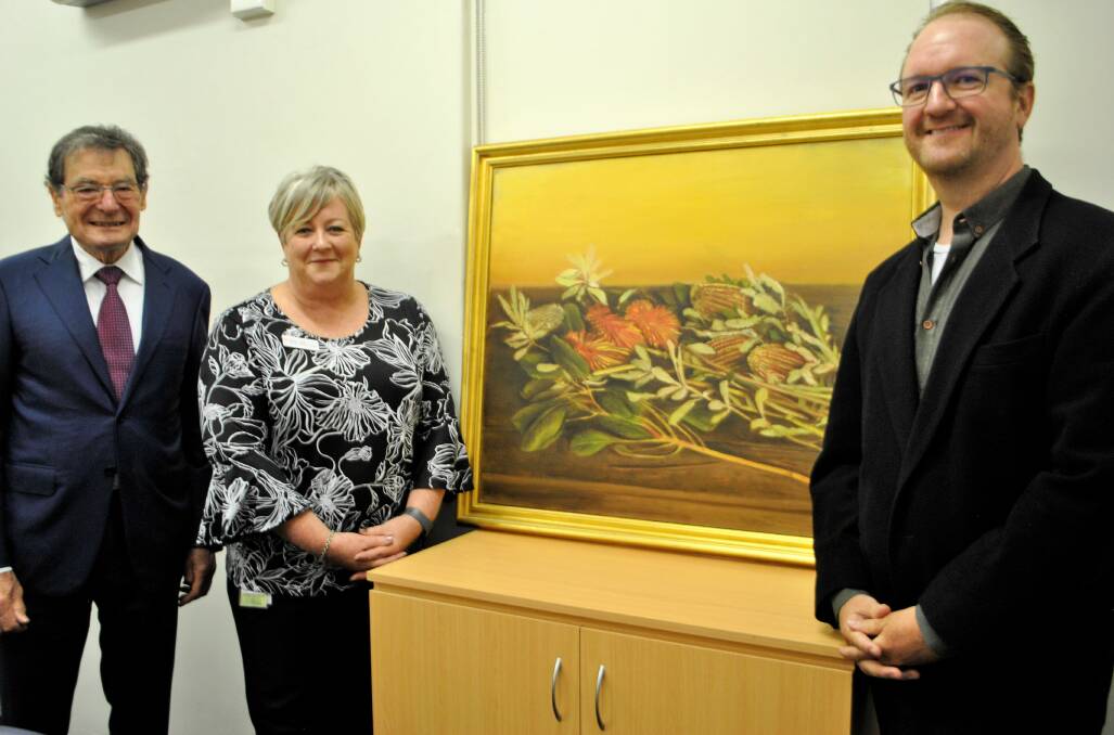 James Fairfax's joint executors Allen Robinson and Edward Simpson with Bowral and District Hospital director of nursing and midwifery Susan Hair with a painting by  Bryan Westwood.
