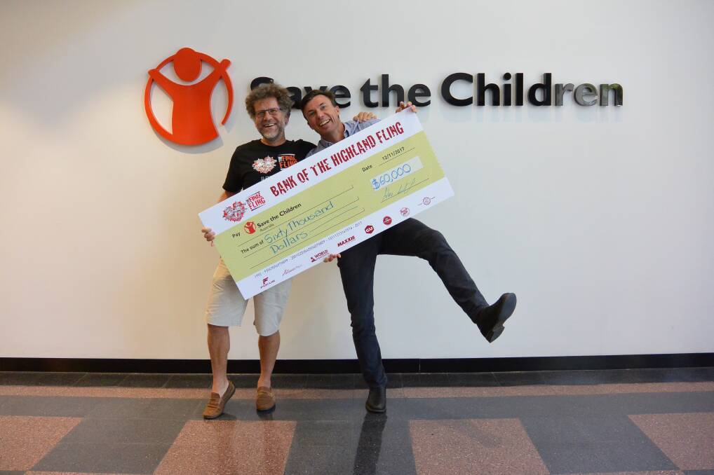 FINAL FLING: Final Fling event director Huw Kingston handing over a cheque for $60,000 to Save the Children CEO Paul Ronalds. Photo: supplied. 