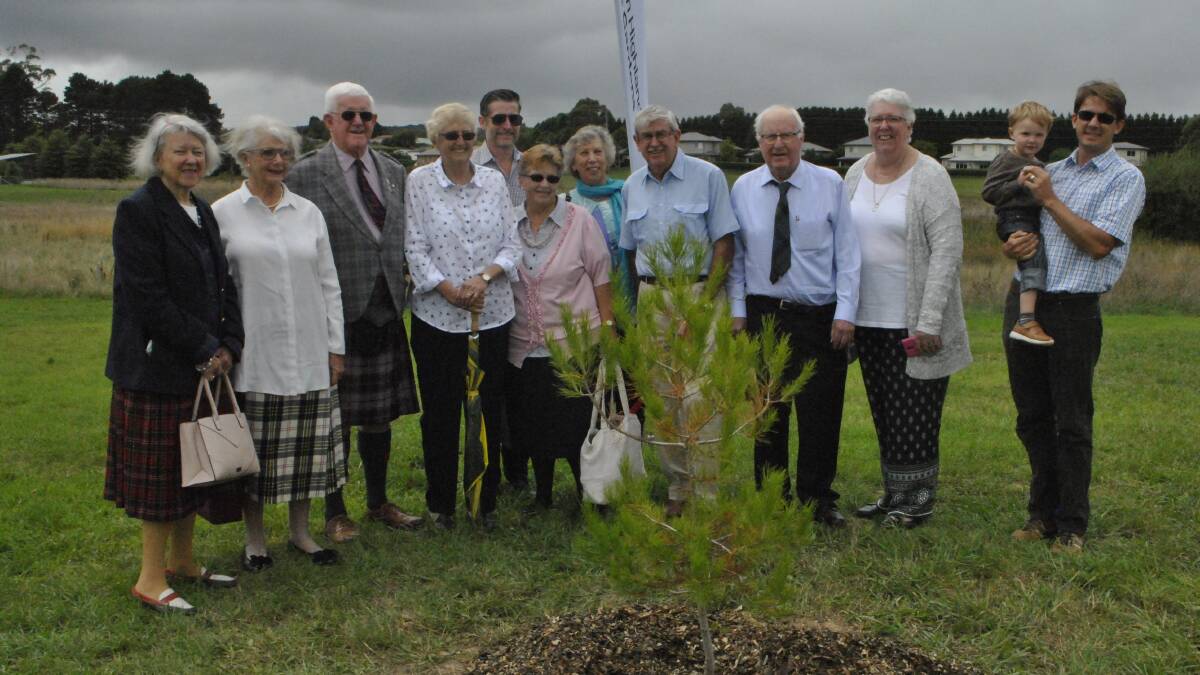 The Macpherson family with the newly planted tree. 