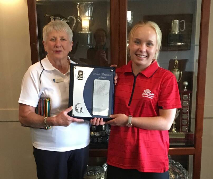 MOST IMPROVED: CSGA President Pam Barker presenting Daisy with the Most Improved Girl Golfer award. Photo: supplied. 