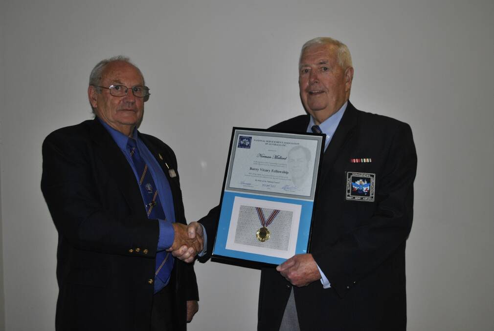 EXEMPLARY SERVICEMAN: Norm Mallard reeciving the Barry Vicary Fellowship award from state president Barry O'Keefe. Photo: Madeline Crittenden. 