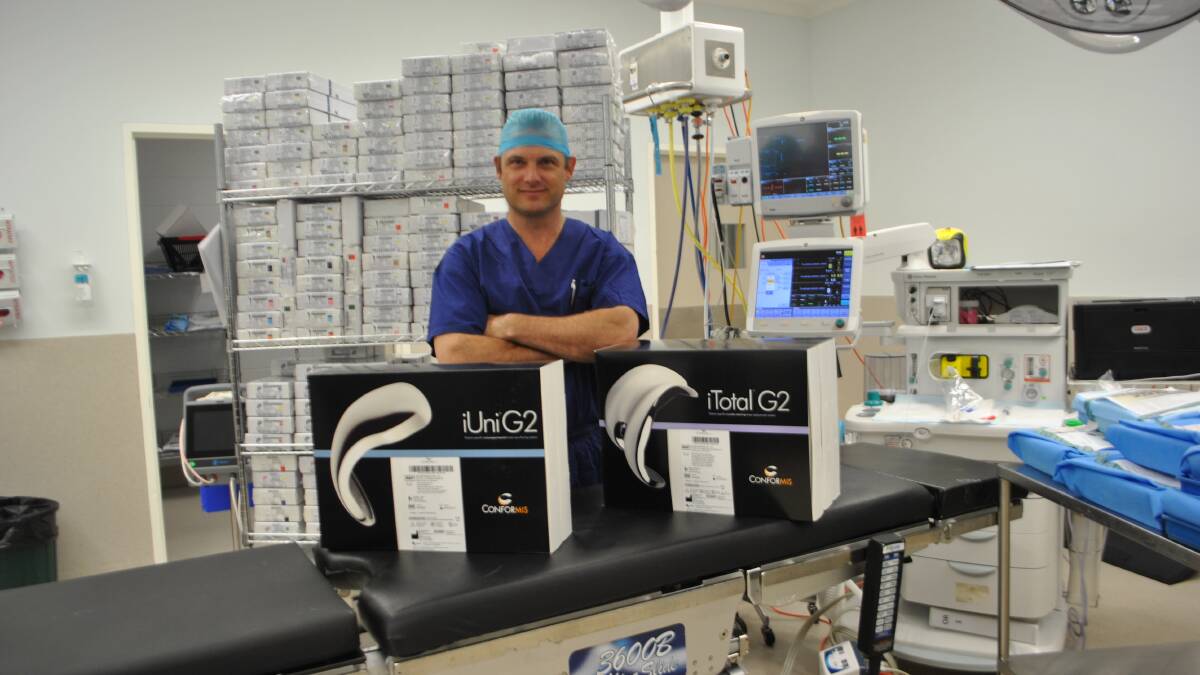 CUSTOMISED KNEE REPLACEMENT: Dr Nick Hartnell with the custom knee replacements before the surgery. Photo: Madeline Crittenden. 