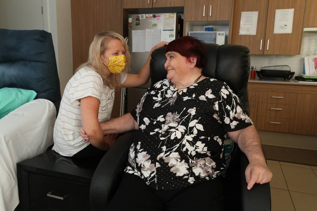 "We're doing all we can to support them": Towradgi resident Joanne Kind - who is exempt from the new mask rules - with her support worker Alison Bard. Picture: Robert Peet.