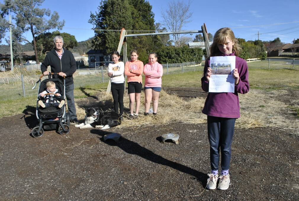CAMPAIGN: Mittagong residents Rodney Wilson, Cooper Linolli, Layla Evans, Caitlin Pankiv, Miah Famer and Melinda Walker-Smith (with her letter to council) at Cook Street Park. Photo: Emily Bennett