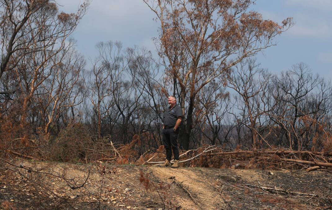 CHARRED: Balmoral resident Mick Duggan among the burnt trees on his property. Photo: Robert Peet