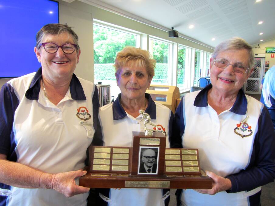 GRINNERS: Enid Brown, Ervy Richetti and Elaine Jones with the 2017 Bert Swan Trophy at Bowral Bowling Club. Photo: Contributed