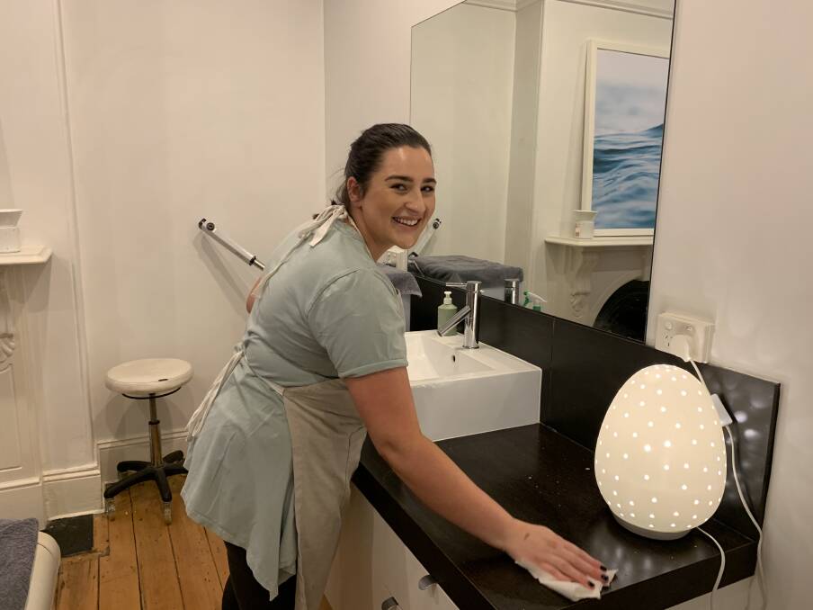 Renee Ioannou of Endota Spa is kept busy cleaning surfaces with antibacterial spray to ensure the safety of all staff and clients.