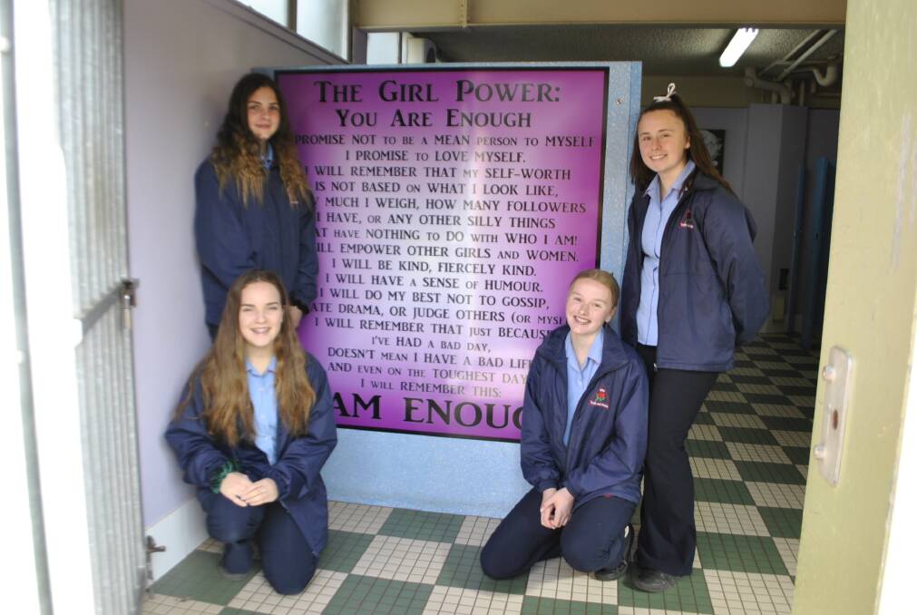 YOU'RE ENOUGH: Moss Vale High School students Holly Hurford, Aurora Hoare, Grace Clay and Isabel Moran in front of one of the affirmation walls. Photo: Emily Bennett
