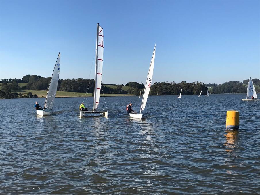 INTENSE RACES: A light westerly breeze saw close and intense racing in both the monohull and catamaran fleets at Fitzroy Falls Reservoir on Sunday. Photo: Blue Robinson