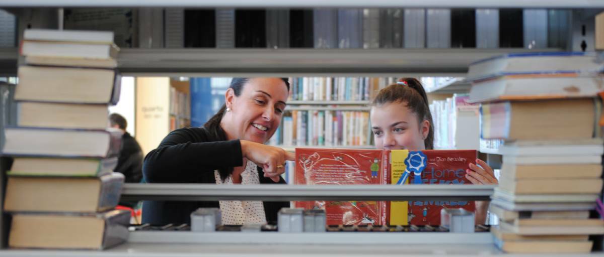 BOOK IN FOR FUN: Librarian Trudy Eccleston and Highlands student Anna Steward at Bowral Library. Photo: File/Emily Bennett