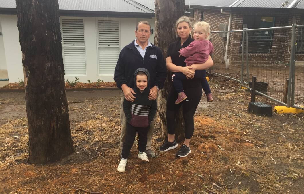 WE WANT ANSWERS: Brian Smith, Hudson Nolan, Maddie Nolan and Audrey Nolan believe the trees in Mary Street are unsafe. Photo: Emily Bennett