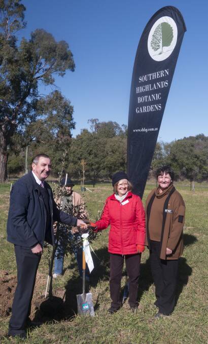 GARDEN BLOOMS: Mayor Duncan Gair, with friends of the gardens Sandy Alsop and Charlotte Webb, celebrating the signing of the lease for the gardens. Photo: Supplied
