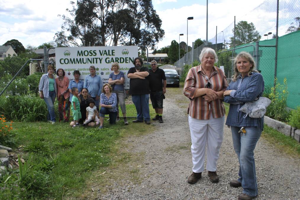 ENOUGH IS ENOUGH: Community garden treasurer Jo O'Brien (front left) and coordinator Jill Cockram (front right) with some of the garden's volunteers. Photo: Emily Bennett