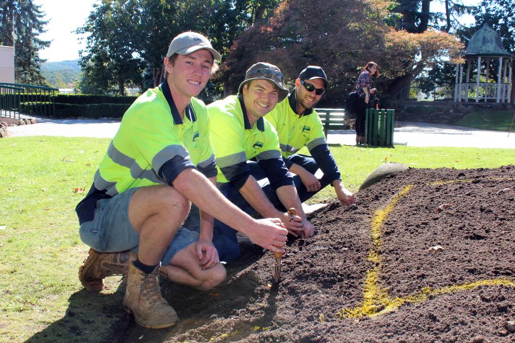 GREEN THUMBS: Jesse Mauger, Tayler Nash and Orry Squires planted bulbs in Corbett Gardens in May in preparation for the annual Tulip Time festival. Photo: Supplied