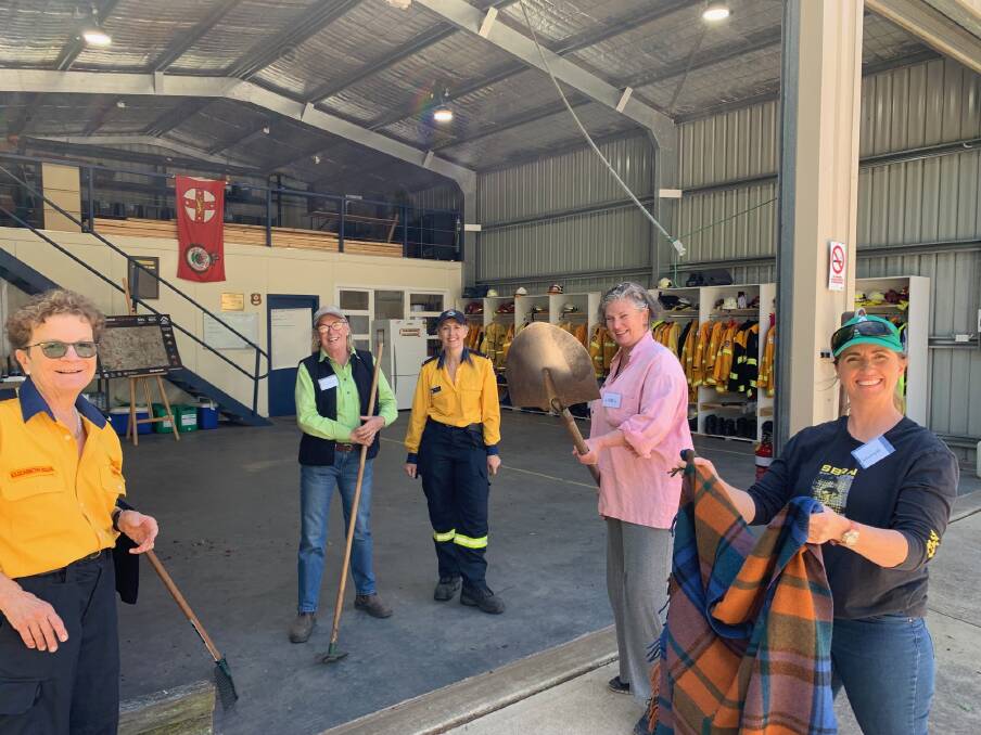 COMMUNITY ENGAGEMENT: Burrawang Rural Fire Brigade Deputy Captain, Elizabeth Ellis and Brigade Training Officer Phillipa Drewett and several Burrawang residents at a previous fire preparation and firefighting skills workshop. Photo: Supplied