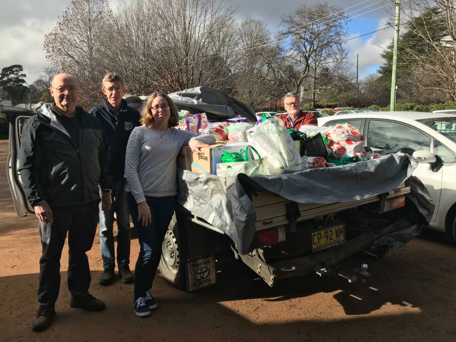 HELPING HAND: Tony Towers, Lucy Earl and Greg Searle with Phil Hand who delivered donations from Southern Highlands Christian School. Photo: Supplied