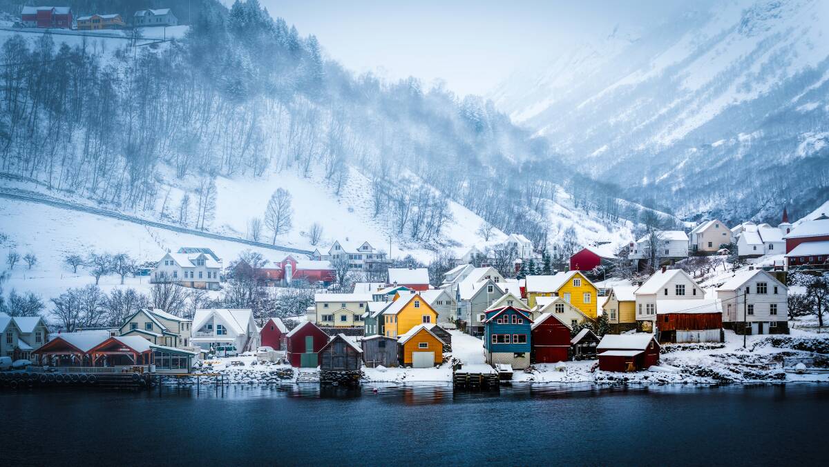 Centuries old: Mountains, snow and these wooden huts on the banks of a fjord make for a typical scene in Norway and are as pretty as a postcard. 