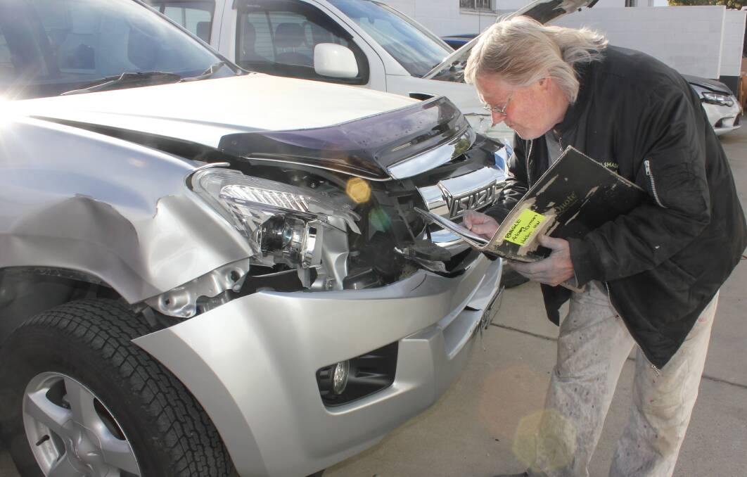 DAMAGE: Bob Christie from Goulburn Smash repairs inspecting damage caused by a kangaroo to a vehicle at his workshop. Photo David Cole. 