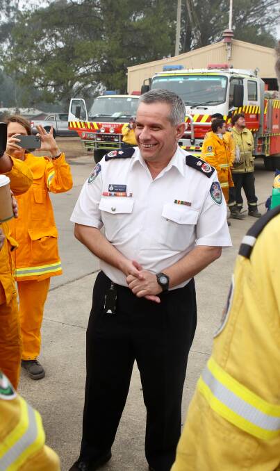 Fan favourite: Deputy RFS Commissioner Rob Rogers greets volunteers at the Wingello staging ground on Sunday. Picture: Adam McLean