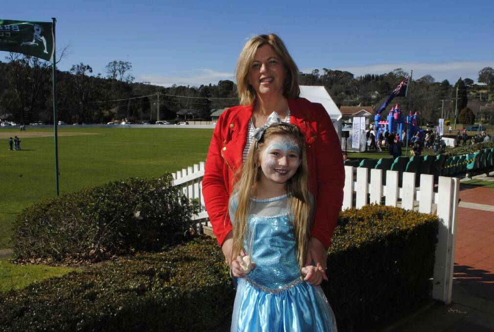 First time festival: Cassie Rhodes and Angelique (7) relax at the first Bowral Winterfest at Bradman Oval, 2016. Photo: file