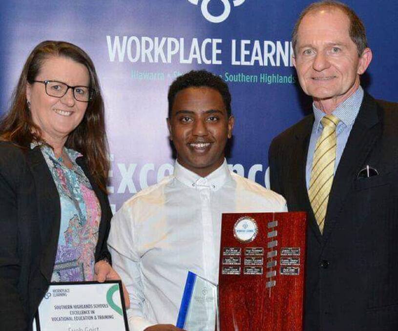 Future secured: Eyob Geist (centre) receiving his VET student of the Year award on November 15. Photo: supplied