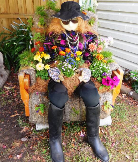 KEEPING GUARD: 'Esmeralda', keeping watch over the street from her throne of flowers, won second place in the 2015 scarecrow competition. Photo: supplied