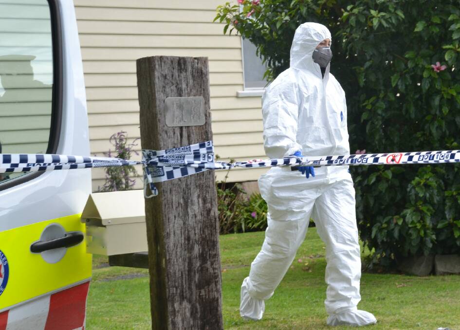 CRIME SCENE: A scientific officer at the Numbaa home.