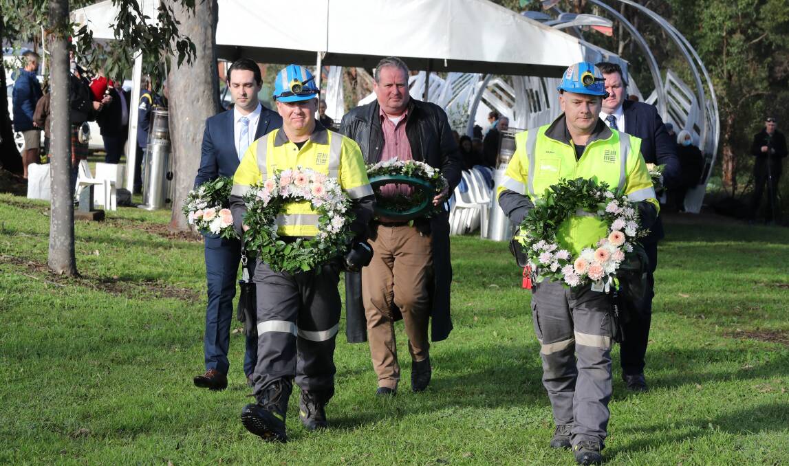 John Nellestein and Daniel Ward of South 32 lead a procession to lay wreaths at the 2022 Appin Mine Disaster Memorial service on Sunday. Picture: Robert Peet