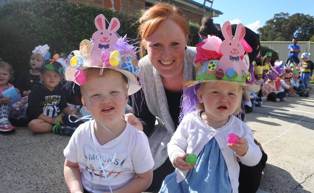 Oliver (3) and Charlotte (18 months) with Alyce Allman, showing off their Easter Hat creations this year at Explorers Learning Academy. Photo: Claire Fenwicke