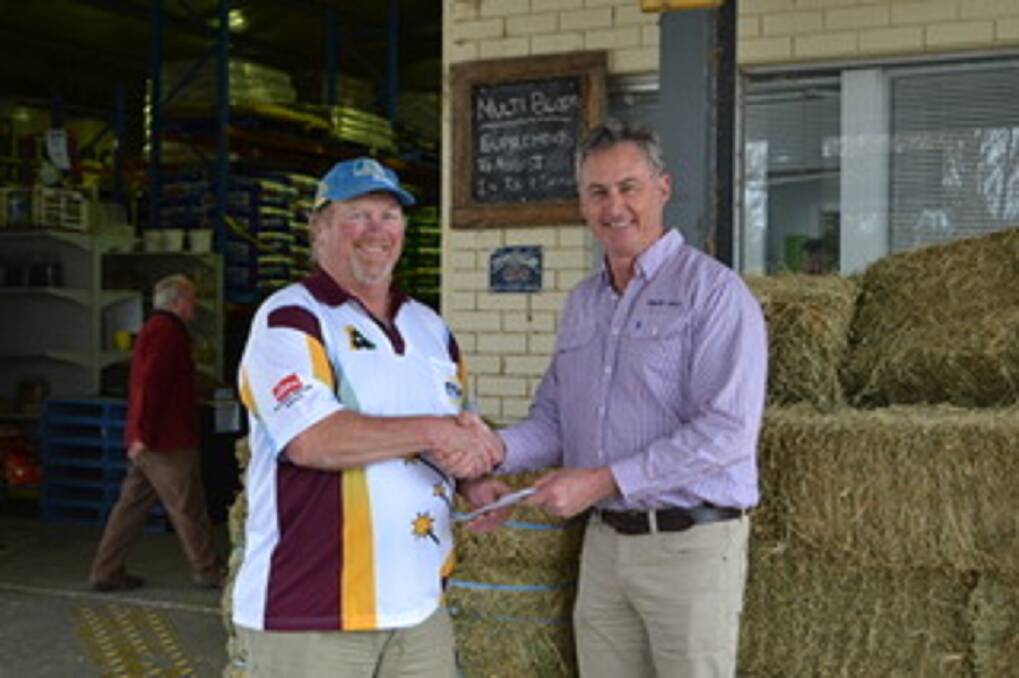Robertson Bowling Club president Graeme Tutt handed a $10,000 cheque to Bowral Co-op CEO CRaig Perkins for the community drought appeal. Photo: suuplied.