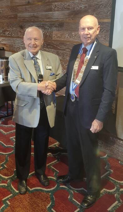 Warm welcome: Outgoing president Malcolm Stephens (left) congratulates new Moss Vale Probus president Jim McGrath. Picture: supplied. 