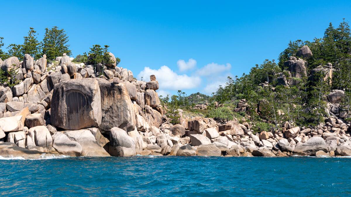 Granite boulders and hoop pines along the island's coast.