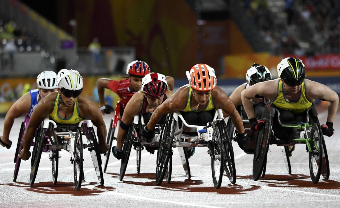 DETERMINED: Madison de Rozario, Eliza Ault-Connell and Angela Ballard of Australia in action during the Women's T54 1500m Final at the Gold Coast Commonwealth Games. Photo: AAP Image/Dean Lewins