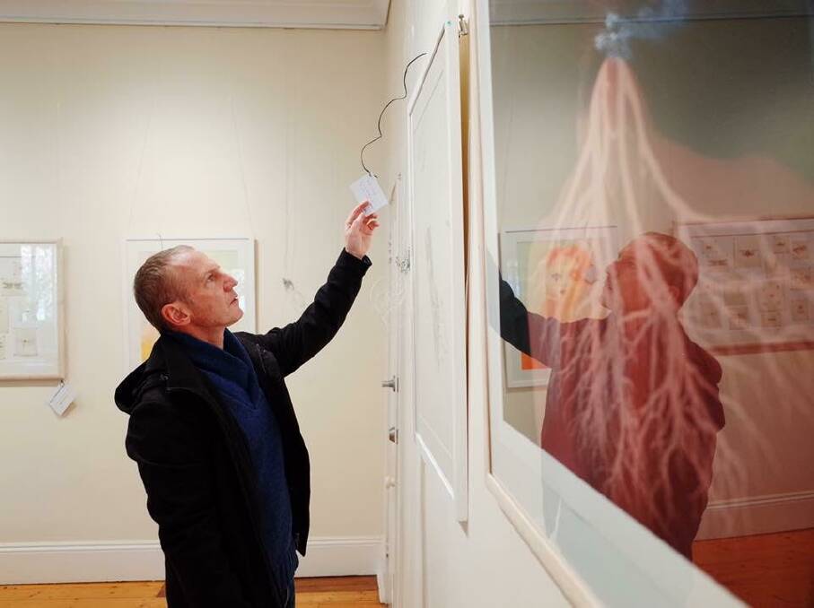 At work: Hamish displaying exhibitions at the Casula Powerhouse Art Centre. Photo: supplied.