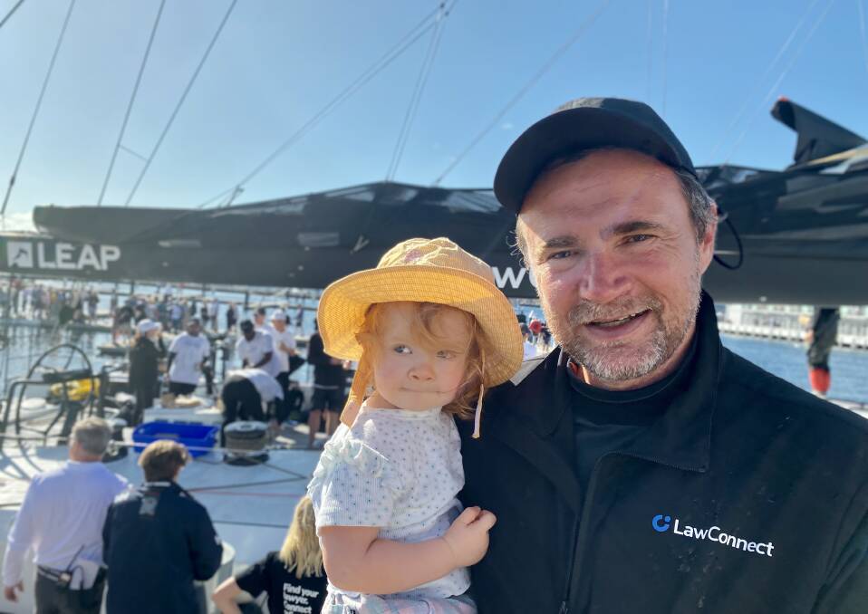 Paul Kimber on dry land with daughter Nell after the finish in Hobart. Picture by Angela Thompson.