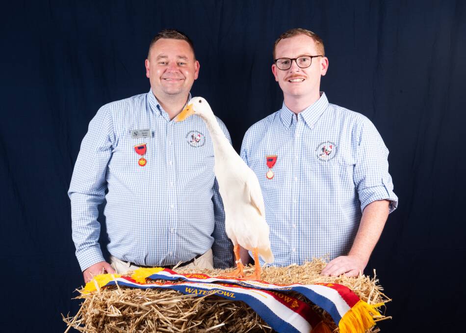 Danny Benn and Gerald Farrugia with Flossi, the 2024 Grand Champion Waterfowl of Show. Supplied picture by Cathy Newton
