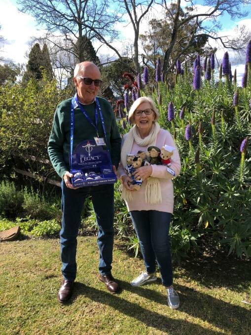 President of Southern Highlands Division of Sydney Legacy, Legatee Tim McKinnon AM and his wife Margie, with badges and Legacy bears, which won't be sold face-to-face this year. 