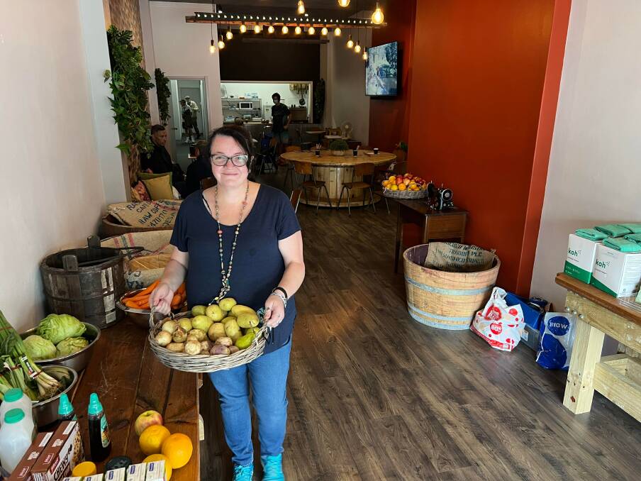 Coordinator of C3 Cares Rebecca Traynor with some of the available produce in their new space on Bong Bong Street. Photo: supplied
