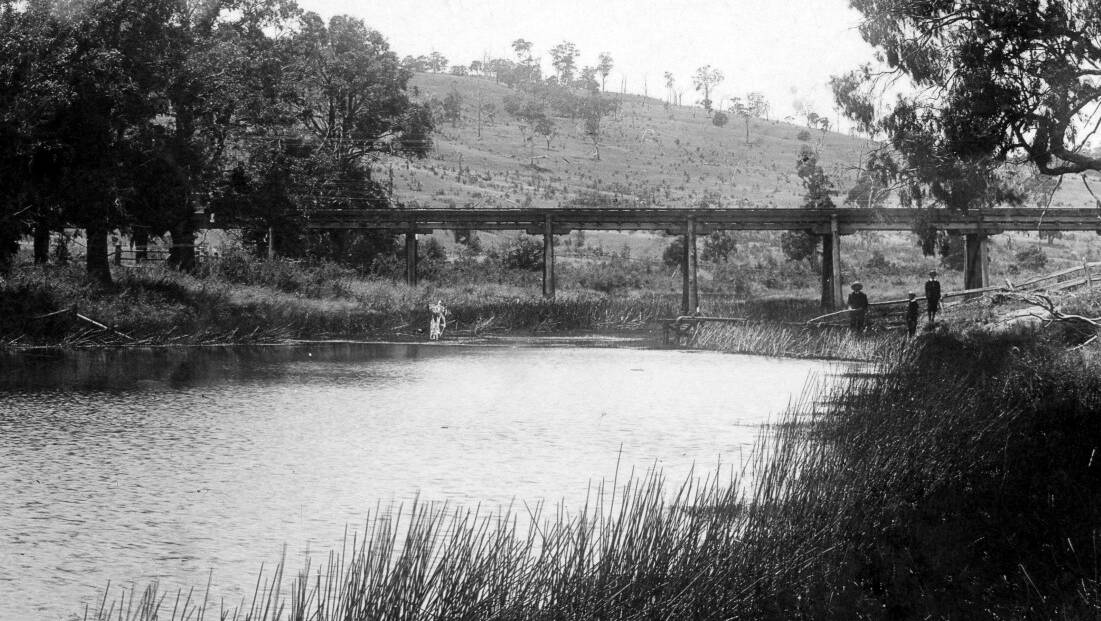 SOUTHERN RAIL: The original 1867 single-track timber trestle viaduct over the Wingecarribee, west end of Bong Bong, 1907. Photo: BDH&FHS.
