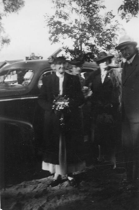 SPECIAL DAY: Sarah Loseby arriving with relatives at her 100th birthday service in St Jude's Bowral, met by Rev Stanley Howard. Photo: BDH&FHS.