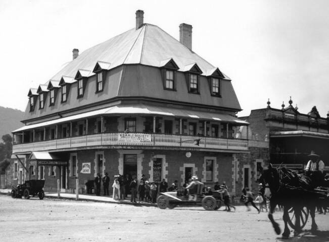 SPEED TRIAL: A motor car race entrant on the Hume Highway out front of Mittagong's Commercial Hotel, c1920. Photo: BDH&FHS.