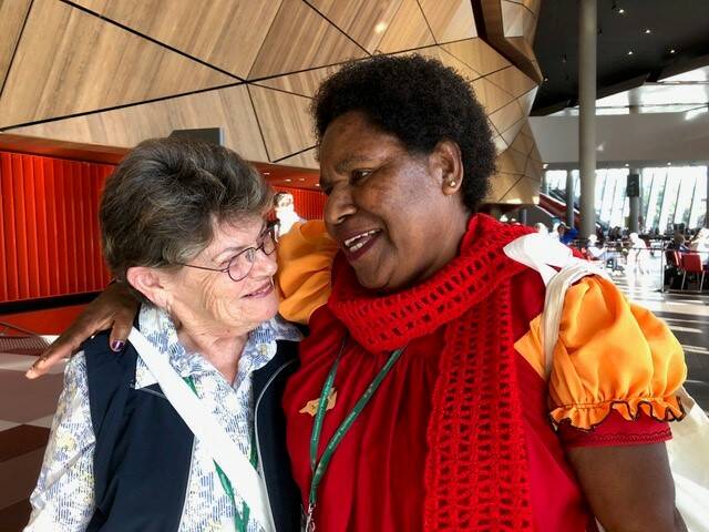 NEW FRIENDS: Beth Sharp of Exeter Branch with Alice Melpa of PNG bonding at the World Conference of the Associated Country Women of the World held in Melbourne last month.