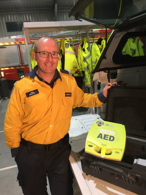 Robertson Rural Fire Service senior deputy captain Jon Bracht with the defibrillator used in the life-saving event.